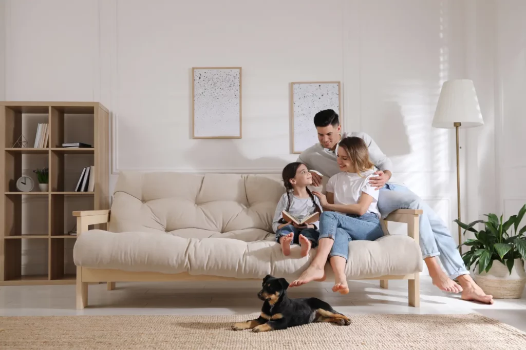A family sitting on a sofa
