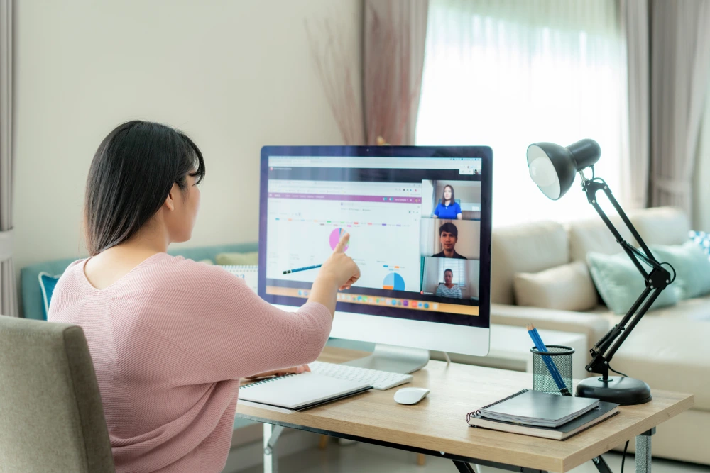 A woman talking to her colleagues in a video conference